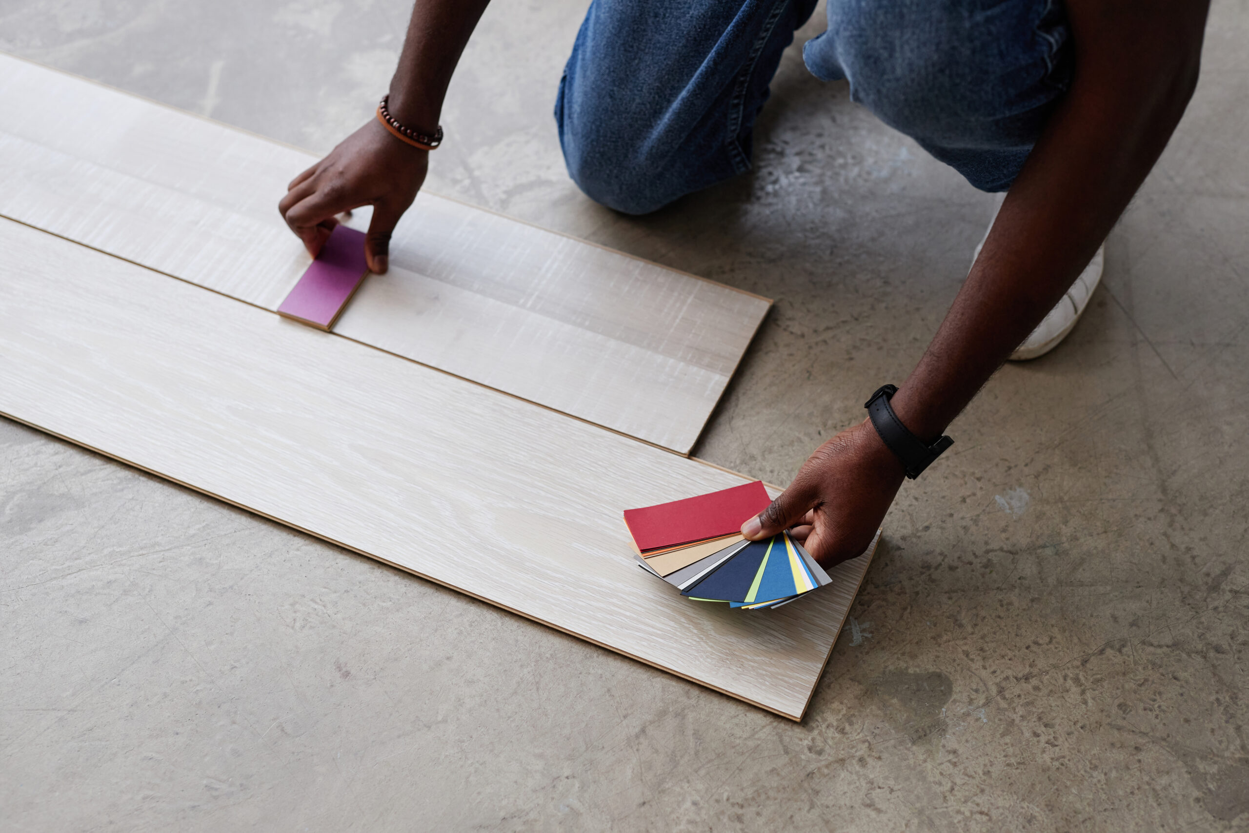 High angle view of designer choosing color for floor from pattern while working over new project